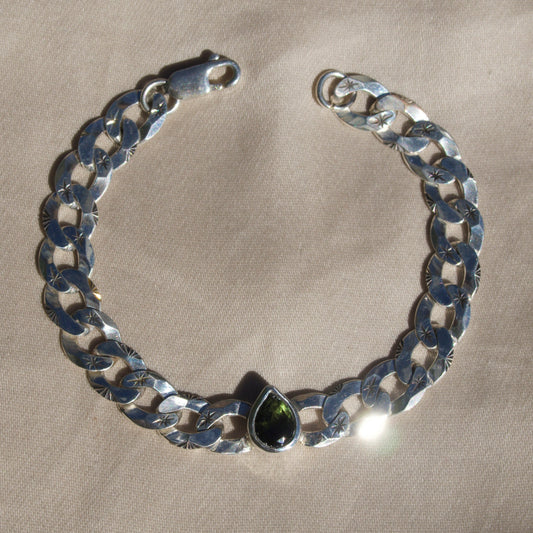pear cut moldavite on a hand engraved curb chain