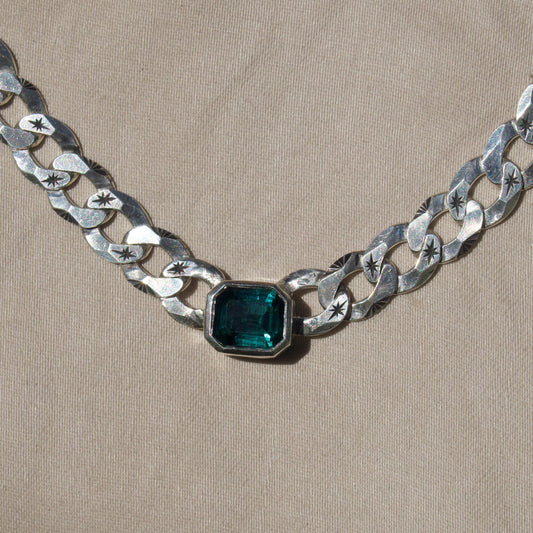 Blue tourmaline emerald cut on a hand engraved curb chain, sterling silver